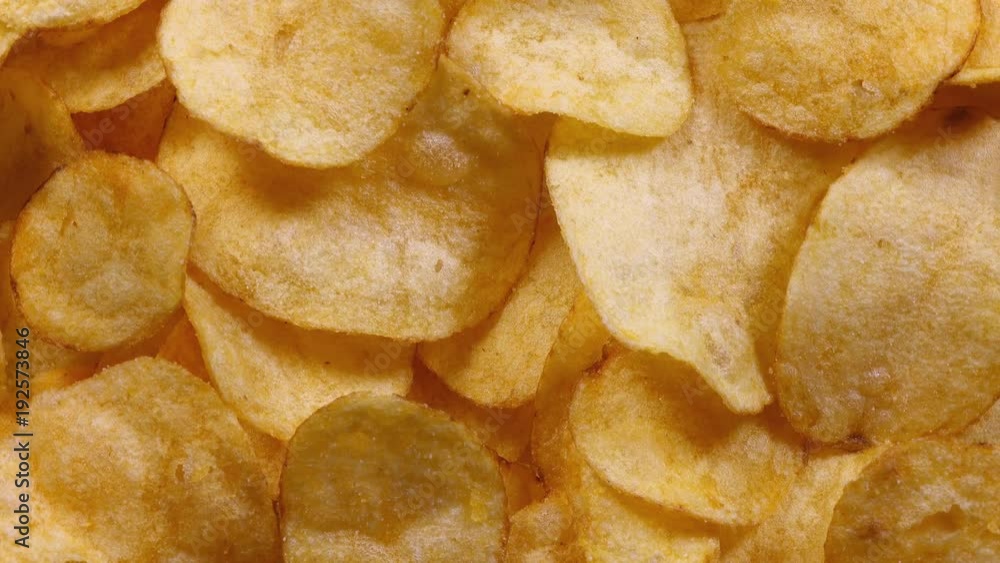 Appetizing potato chips rotating in 4K. Closeup top view.
Appetizing potato chips rotating in 4K. Closeup top view.