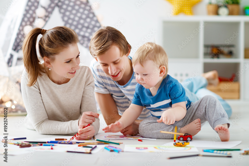 children's creativity. happy family mother father and son draw together children's creativity. happy family mother father and son draw together