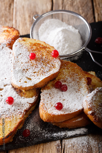 Fried sweet toast with sugar powder and cranberries close-up. vertical