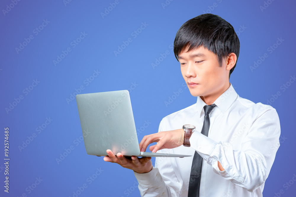 young smiling asian businessman holding laptop young smiling asian businessman holding laptop