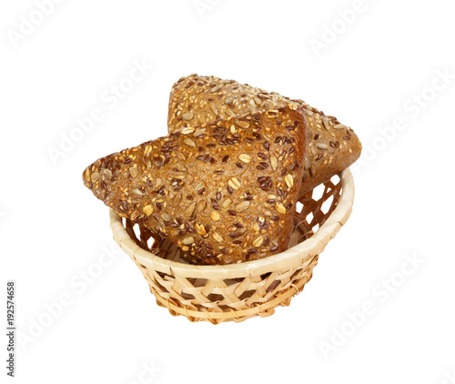 Closeup of rye bread with flax seeds on basket isolated on white background