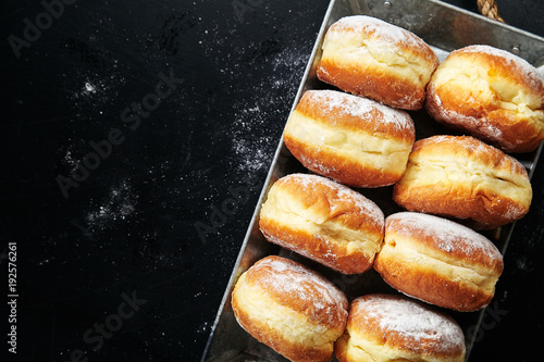 Sufganiyot donuts with jelly on black background