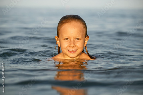 Girl having fun bathing in the sea.