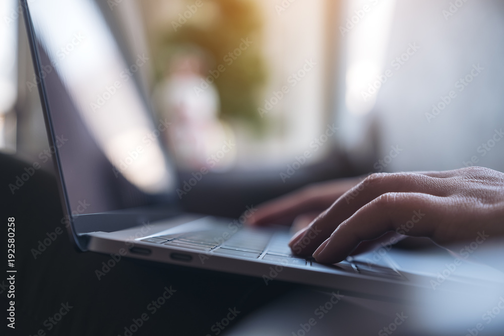 Closeup image of hands working and typing on laptop keyboard on the table Closeup image of hands working and typing on laptop keyboard on the table