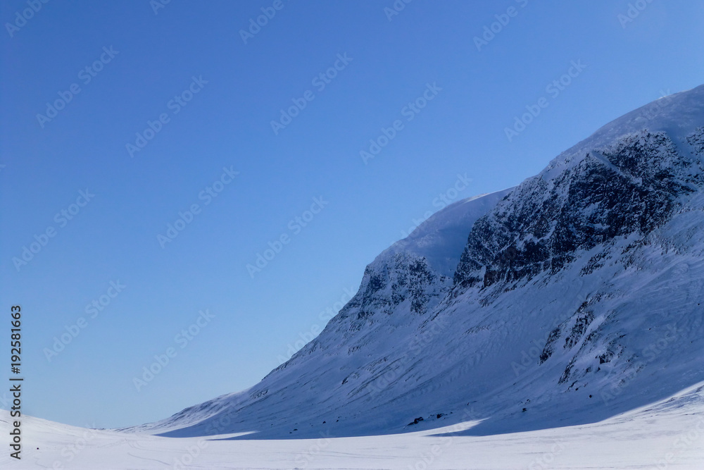 A large snowy mountain in Sweden near the polar circle.