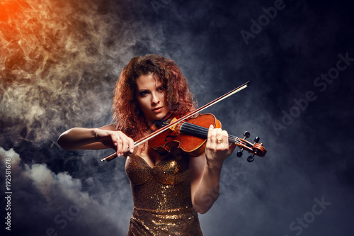 Violinist girl performs on stage. photo