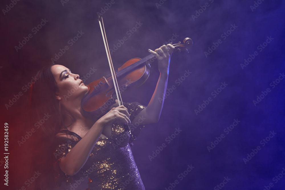 Fototapeta premium Violinist girl performs on stage.