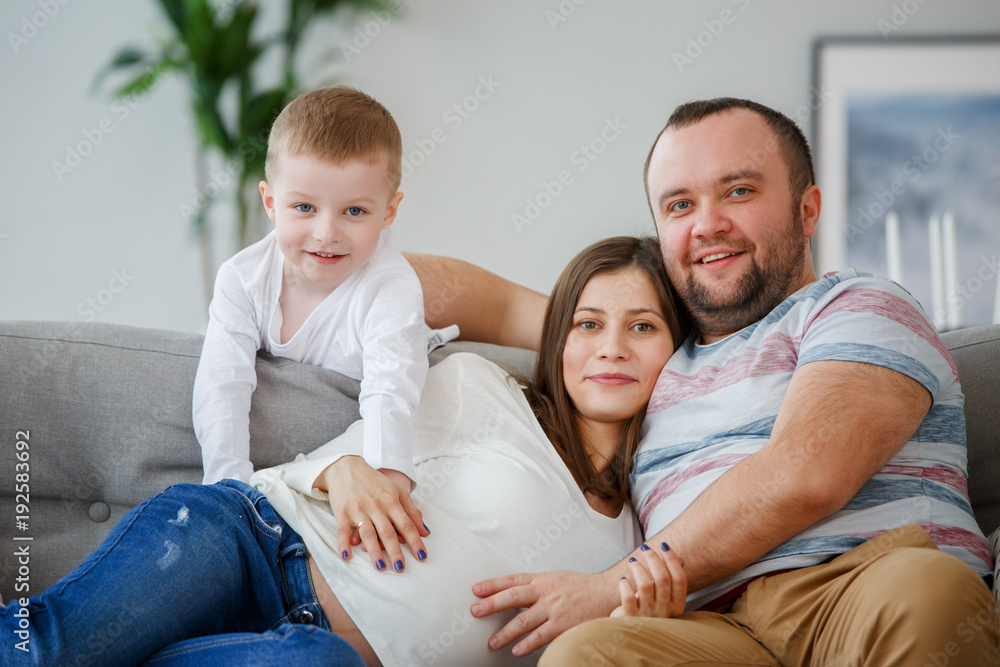 Picture of happy family with son sitting on sofa Picture of happy family with son sitting on sofa