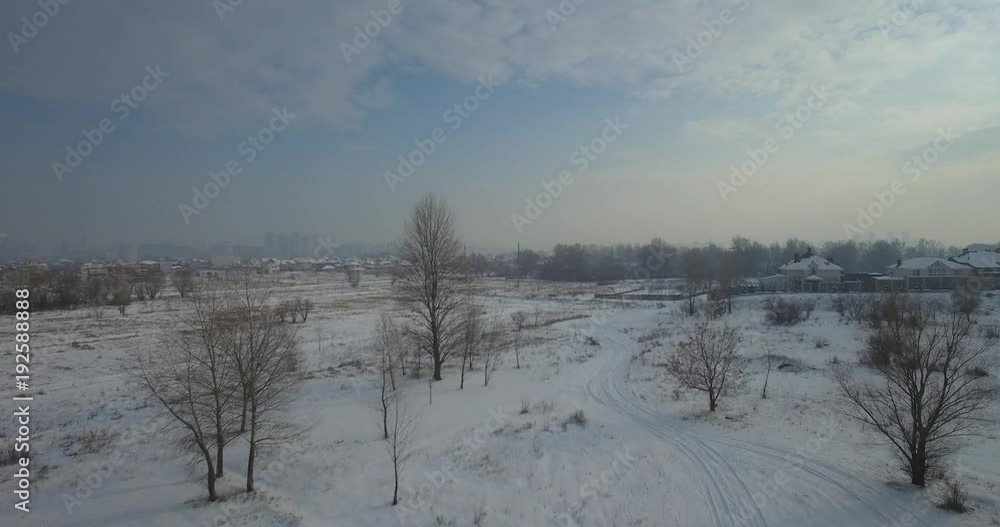 A winter field with a dawn and an orange sun in the sky with clouds. Aerial drone view of winter snowy countryside at sunset. Aerial drone view of winter snowy countryside. Village in the forest. A winter field with a dawn and an orange sun in the sky with clouds. Aerial drone view of winter snowy countryside at sunset. Aerial drone view of winter snowy countryside. Village in the forest.