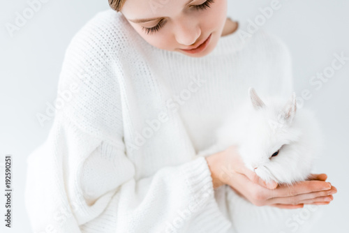 Fototapeta Naklejka Na Ścianę i Meble -  cropped shot of girl holding white furry rabbit isolated on white