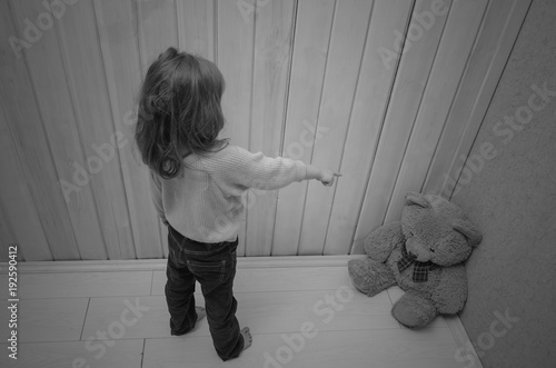 punishes, puts in the corner of the toy bear girl, child photo