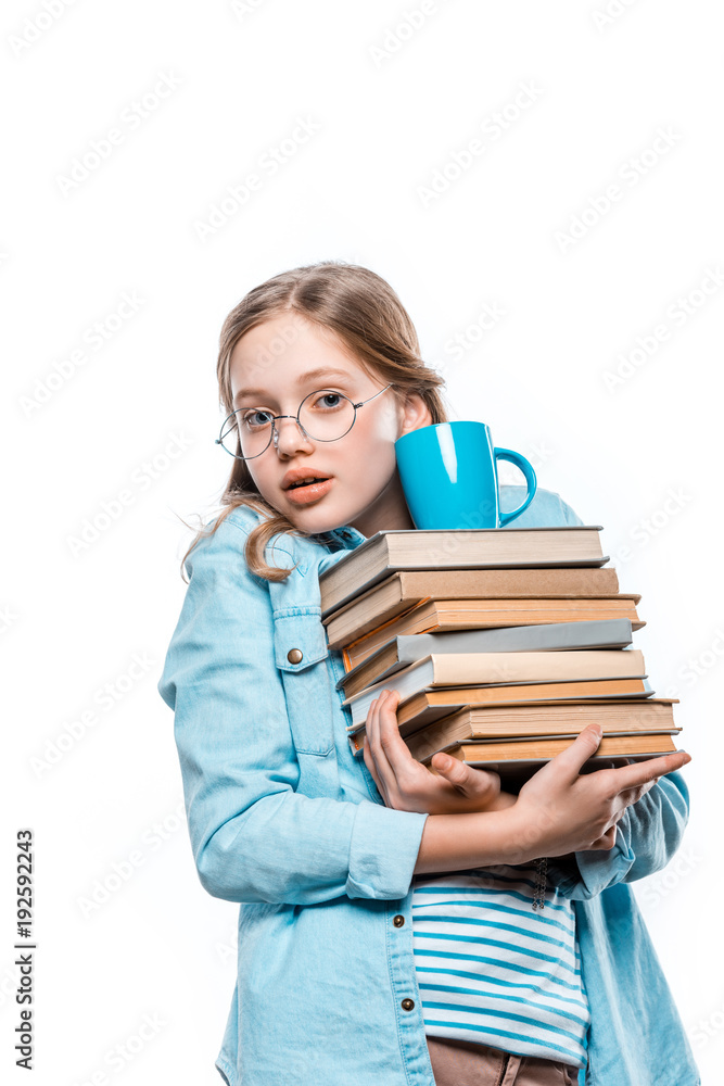 girl in eyeglasses holding stack of books with cup on top and looking at camera isolated on white girl in eyeglasses holding stack of books with cup on top and looking at camera isolated on white