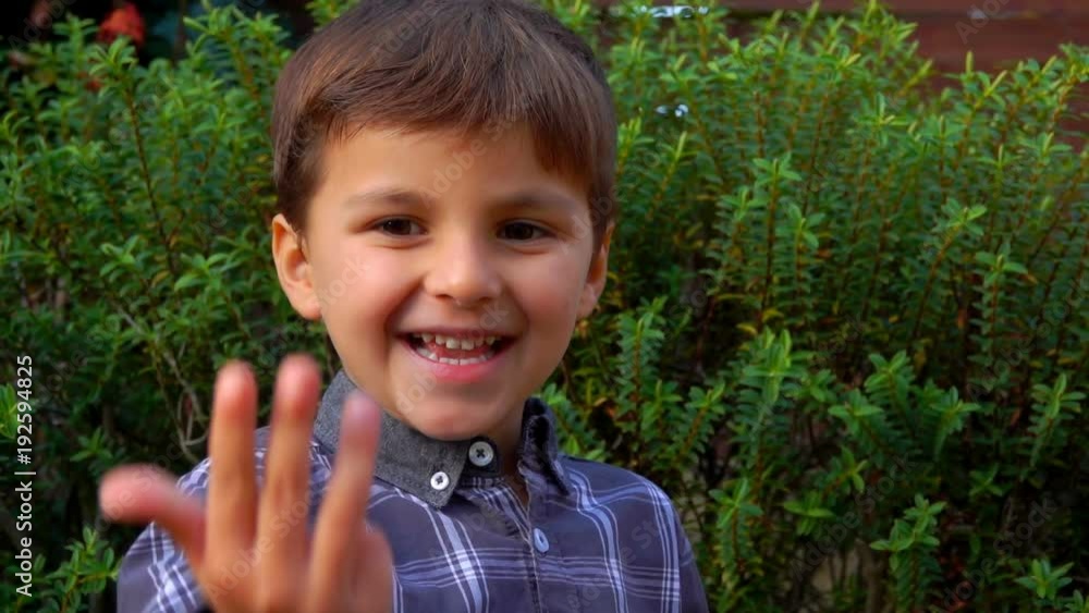 Cute little boy counts on the fingers up to ten Cute little boy counts on the fingers up to ten