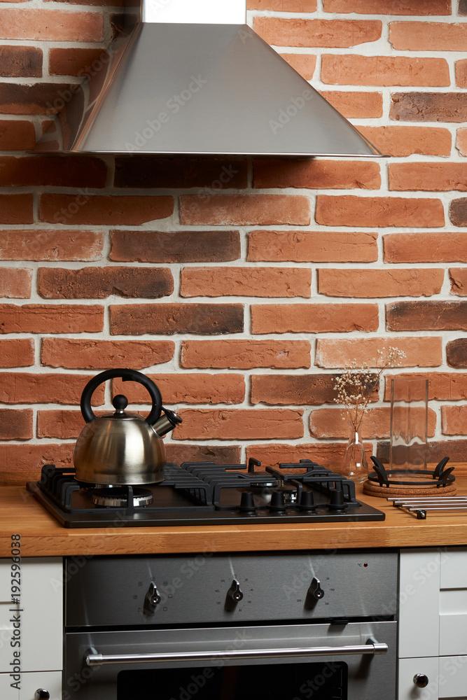 Modern kitchen with brick wall