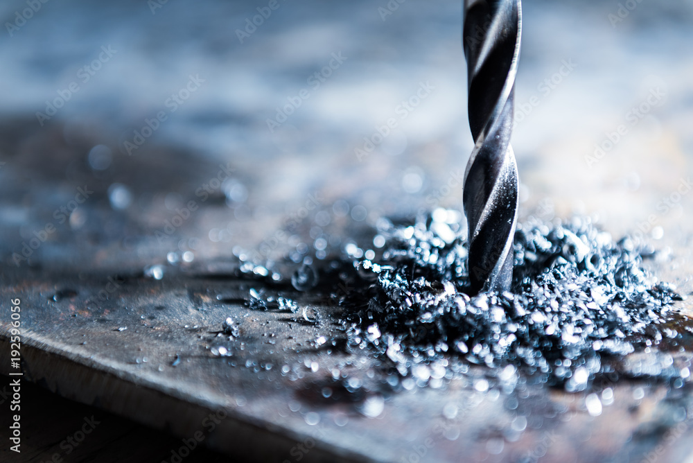 close up of drilling a hole with metal shavings - obrazy, fototapety, plakaty 