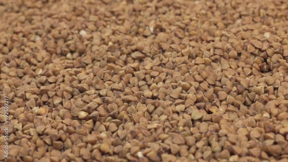 Rotation of the background of whole grains of buckwheat. Close-up Rotation of the background of whole grains of buckwheat. Close-up