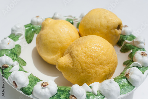 Three fresh lemons from Sorrento on a beautiful decorated plate