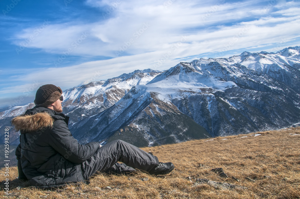 hiker high at the mountains looks at the ultimate aim of his trip.
