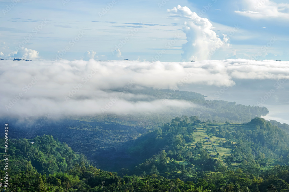 Mount Batur on the island of Bali. Rice fields. The photo is taken above the clouds.