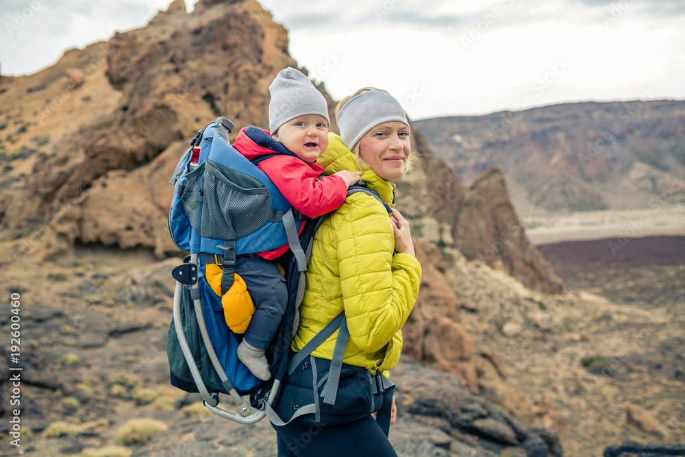 Family hike, mother with baby in backpack