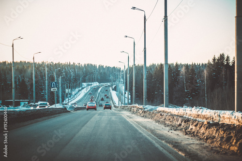 Obraz na plátně Evening traffic. Cars go by the bridge.