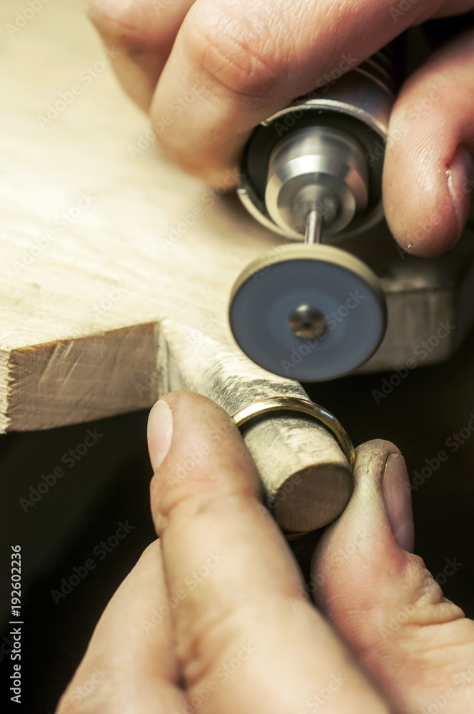 Fototapeta premium Craft jewelery making. Ring polishing. Macro shot.