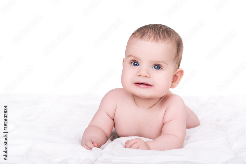 adorable smiling baby girl or boy with blue eyes lying on soft blanket, isolated on white adorable smiling baby girl or boy with blue eyes lying on soft blanket, isolated on white