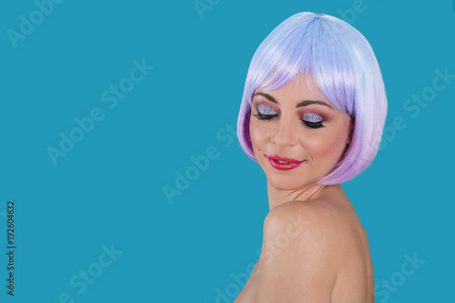 Young woman with purple hair on blue