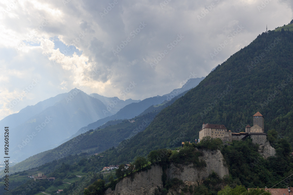 Tyrol Castle, dark storm clouds and mountain panorama in Tirol, South Tyrol