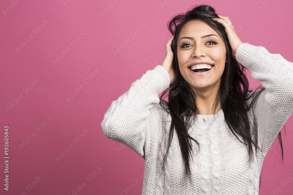 Terrific brunette model expressing surprised emotions while holding her head on indoor photoshoot. Stylish dark hair woman having fun in pink studio Terrific brunette model expressing surprised emotions while holding her head on indoor photoshoot. Stylish dark hair woman having fun in pink studio