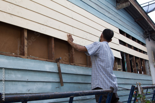 Fototapeta A carpenter is repairing the house.