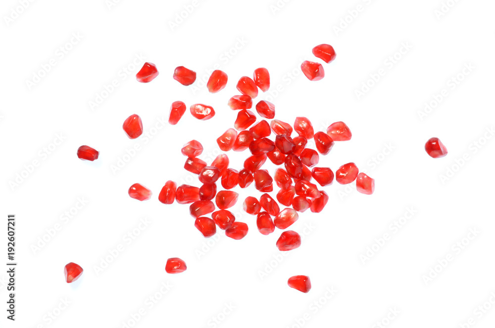 Isolated pomegranate seeds, top view closeup image of scattered pomegranate seeds isolated on white background, red seeds of pomegranate after peeled, tropical fruit healthy food, red fruit grain