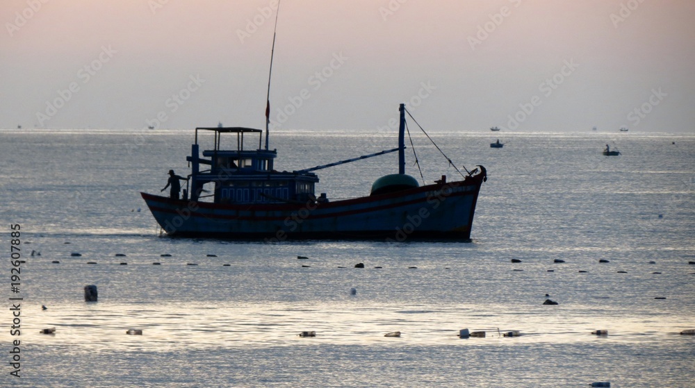 Fishermen at sunrise in the village of Mui Ne.