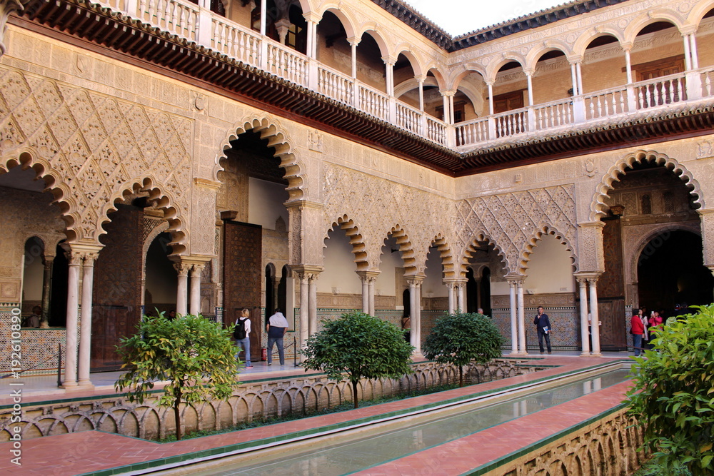  Beautiful courtyard of the Alcazar with the water channel and the arched gallery (Patio de las Doncellas)/Seville, Spain 