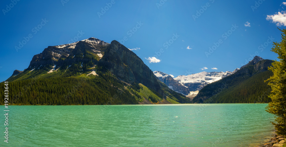 Lake Louise  surrounded by mountain peaks and glaciers