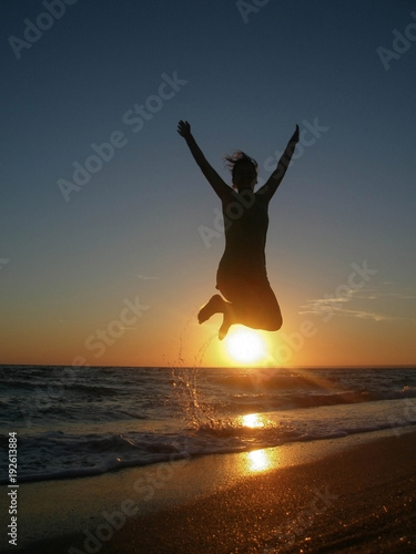 silhouette of a man jumping in the sunset