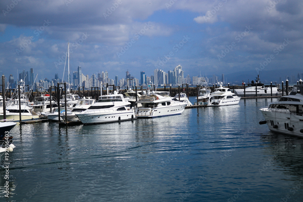 Marina full of yachts with dark clouds rolling in; scenic vacation background