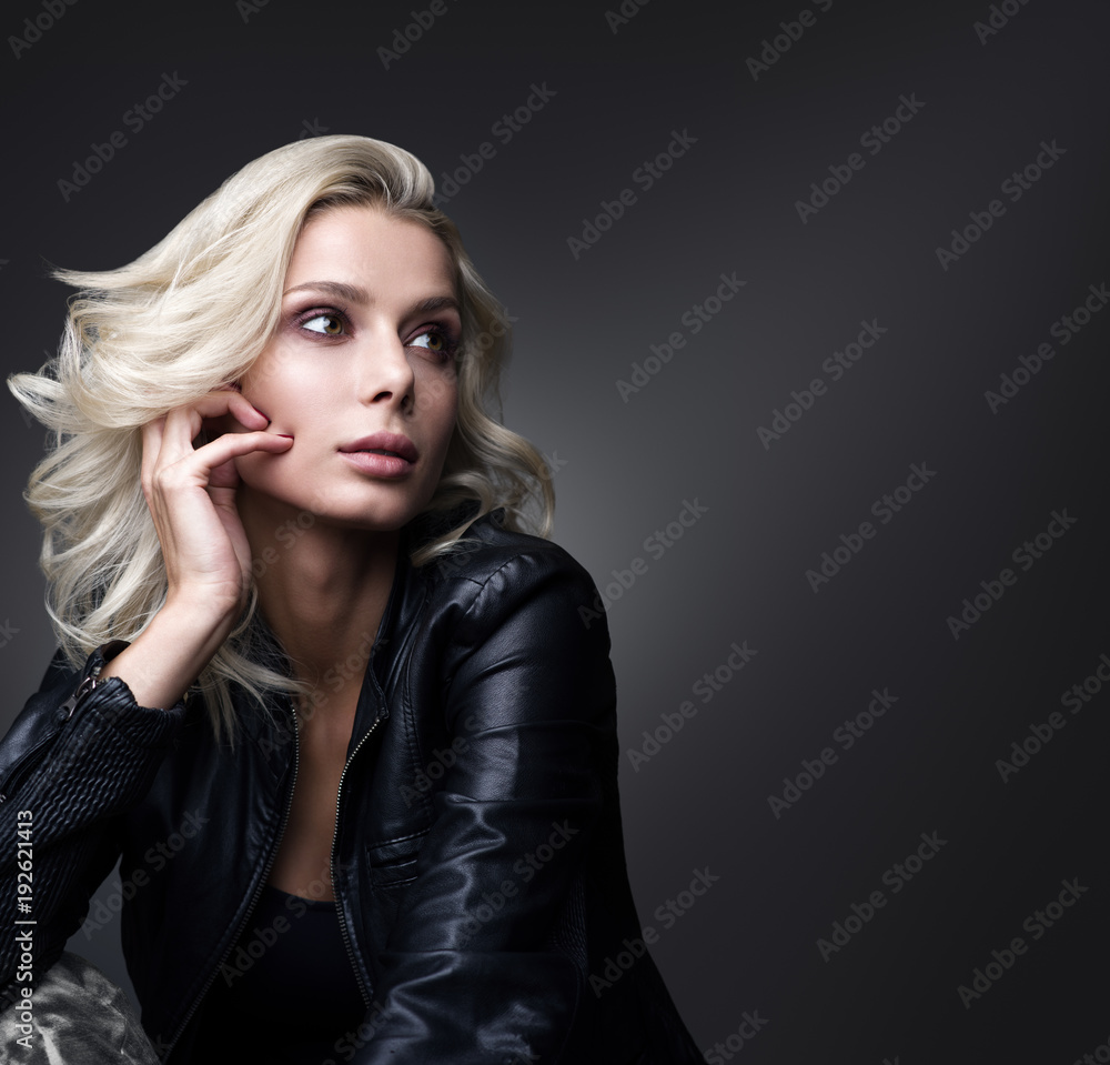 Portrait of beautiful young woman with a free space on a dark gray background Portrait of beautiful young woman with a free space on a dark gray background