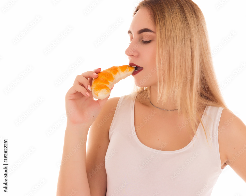 Young pretty girl eats croissant, studio Young pretty girl eats croissant, studio