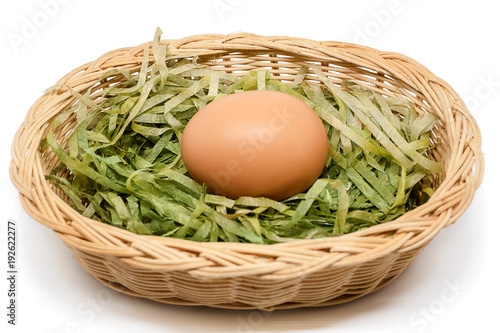 Egg in the wicker basket on...