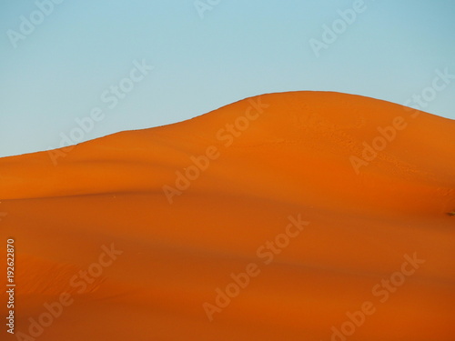 Peak of ERG CHEBBI dunes near MERZOUGA with landscape of sandy desert formations in southeastern MOROCCO