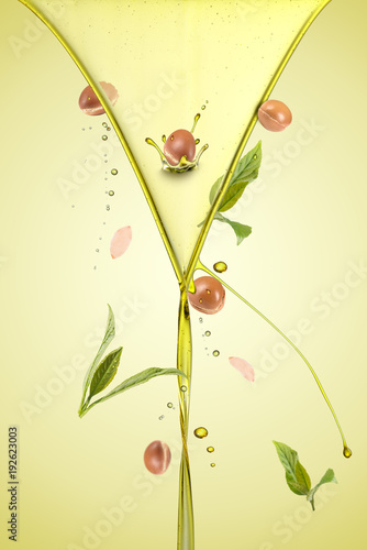 Argan oil splash with argan fruits