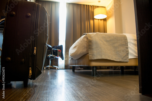 Fotografia, Obraz View of Close Up of Black Suitcase in a Four Stars Hotel Suite