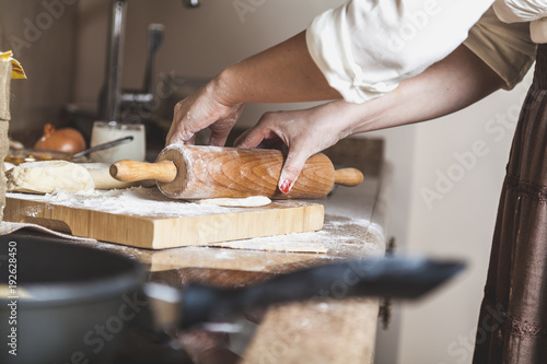 Female hand rolled dough with rolling pin