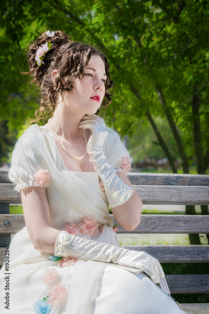 Naklejka premium Portrait of woman in bride dress with a book in their hands.