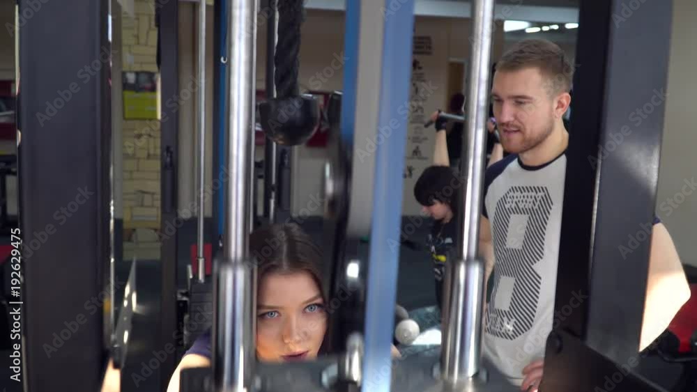 sports girl under the supervision of a trainer doing exercises on legs sports girl under the supervision of a trainer doing exercises on legs