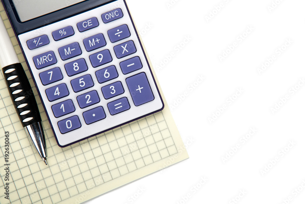 One big calculator with yellow checkbook and stationery on a white table One big calculator with yellow checkbook and stationery on a white table