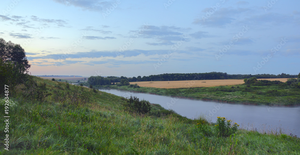 Summer morning.Twilight.Foggy landscape with river.River Krasivaya in Tula region,Russia.Colorful sunrise.Field of ripe wheat.