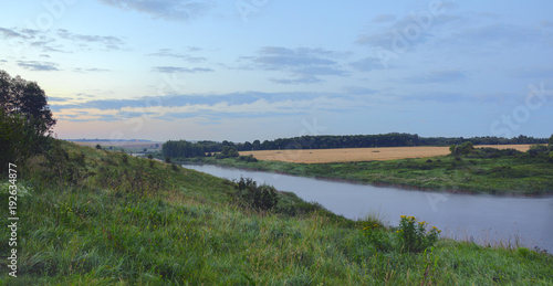 Summer morning.Twilight.Foggy landscape with river.River Krasivaya in Tula region Russia.Colorful sunrise.Field of ripe wheat.
