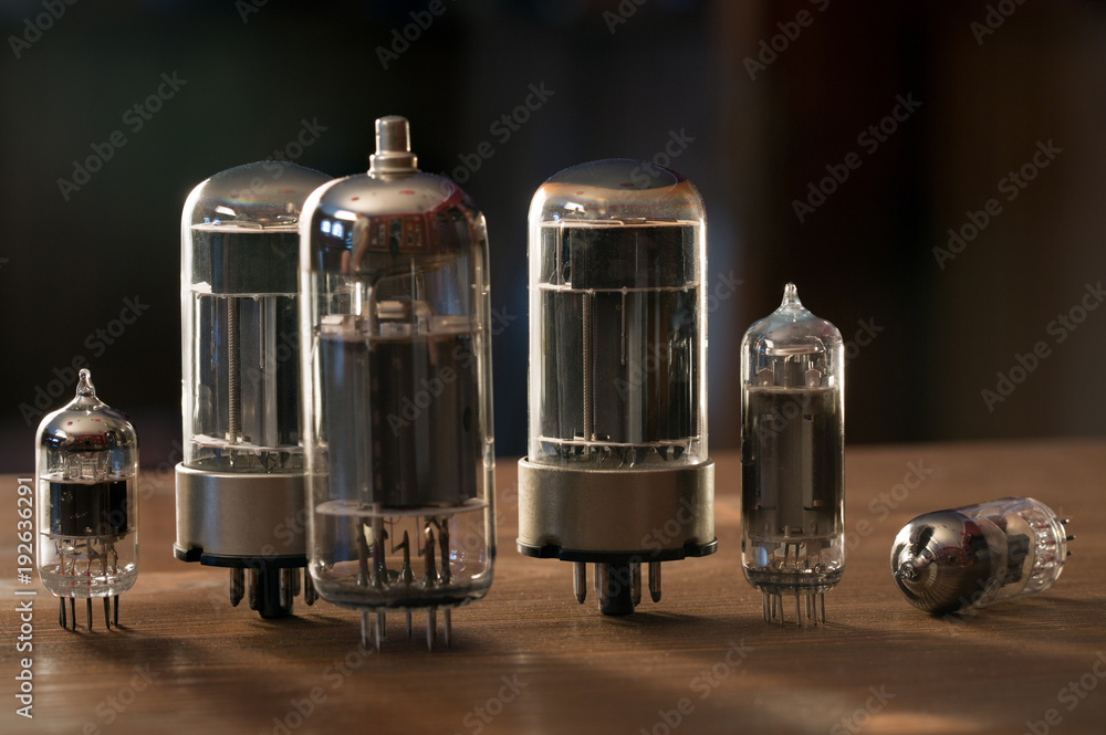 Various radio tubes on a wooden table Various radio tubes on a wooden table